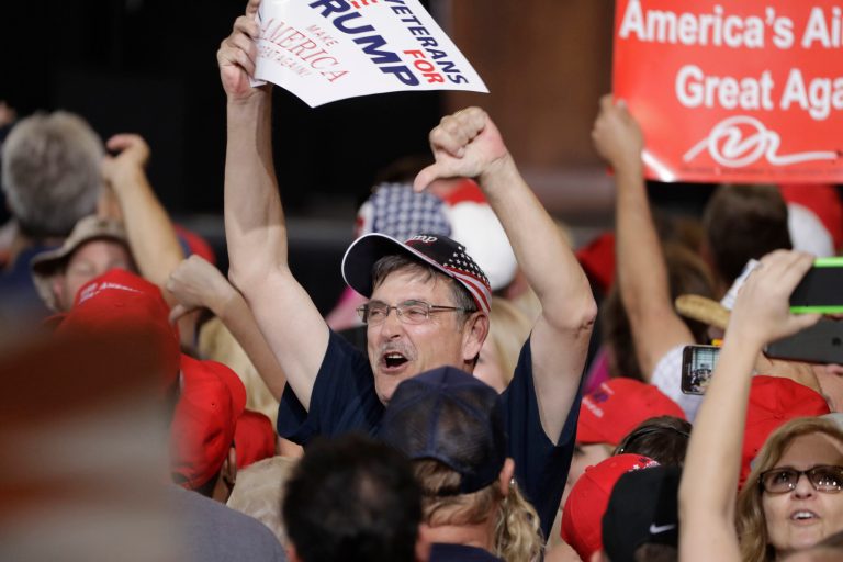 Supporters of President Donald Trump make gestures to the media during a campaign rally Saturday, Feb. 18, 2017, in Melbourne, Fla. (AP Photo/Chris O'Meara)