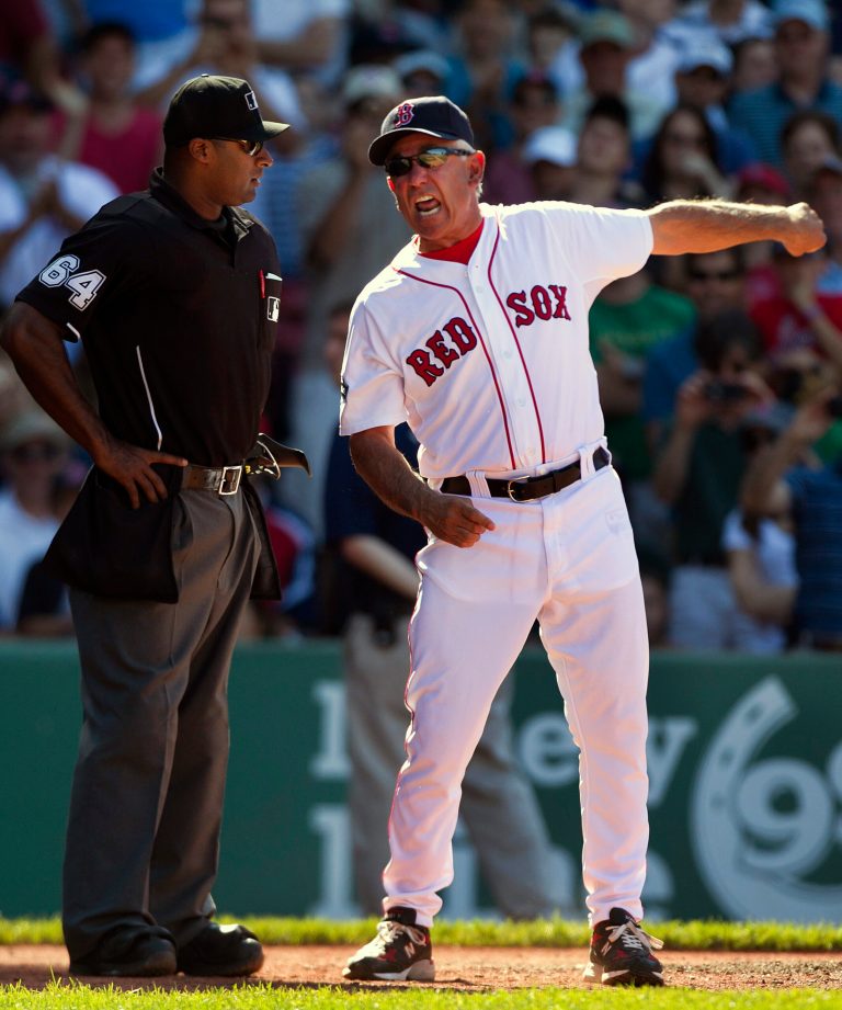   Boston Red Sox manager Bobby Valentine, right, argues with home plate umpire Al Porter, left, about a called strike on Red Sox's Dustin Pedroia in the ninth inning of a baseball game against the Washington Nationals at Fenway Park in Boston, Sunday, June 10, 2012. The Nationals defeated the Red Sox 4-3. Valentine had already been thrown out of the game before going to home plate. (AP Photo/Steven Senne)  