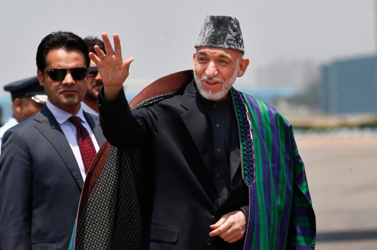 FILE - This May 26, 2014 file photo shows Afghan President Hamid Karzai in New Delhi, India. Civilian assistance to Afghanistan was always slated to shrink with America's military footprint, but U.S. aid officials were caught off-guard when Congress, upset by testy relations with Afghan President Hamid Karzai, slashed civilian aid by 50 percent this year. War-weary lawmakers, content with the level of Afghan aid already in the pipeline, backed the cut, but officials with the U.S. Agency for International Development warn that reducing aid too quickly is risky. (AP Photo/Saurabh Das, File)