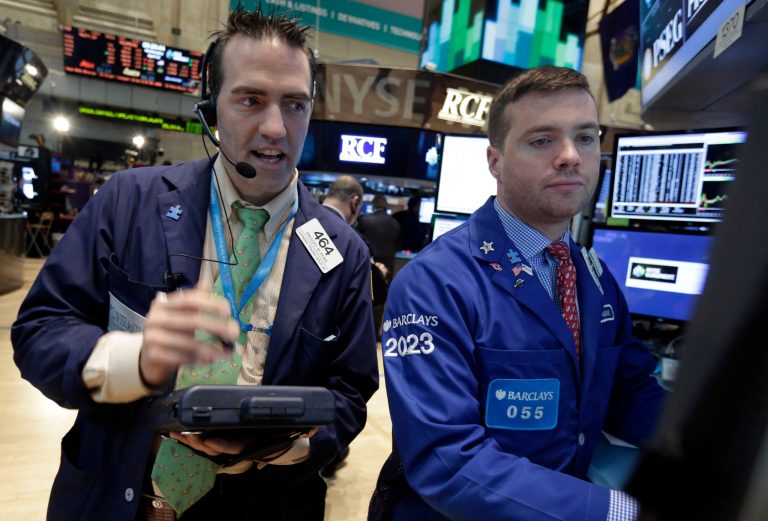 Trader Gregory Rowe, left, and specialist Frank Masiello work on the floor of the New York Stock Exchange Wednesday, April 23, 2014. The stock market slipped Wednesday after rallying for six straight days as investors worked through another round of quarterly earnings reports from U.S. companies. (AP Photo/Richard Drew)