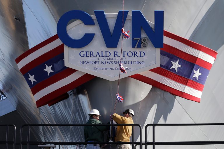 Newport News Shipbuilding workers prepare for the christening of the Navy's newest nuclear-powered aircraft carrier USS Gerald R. Ford at the shipyard in Newport News, Va. (AP Photo/Steve Helber)