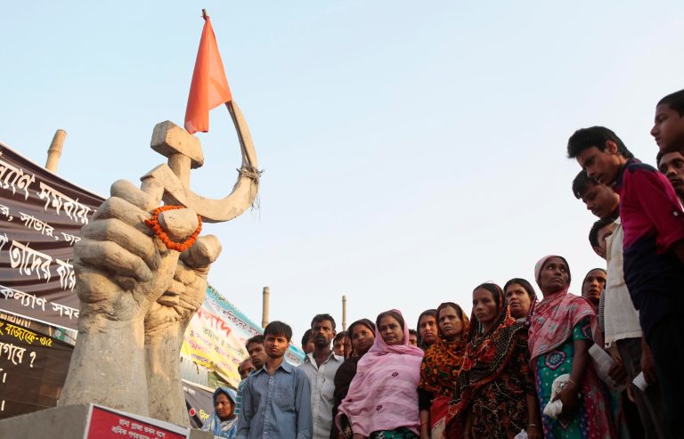 Relatives of the victims of the April 24 Rana Plaza building collapse, gathers at the site of Rana Plaza building collapse ahead of the first anniversary, the worst tragedy in the history of the global garment industry, in Savar near Dhaka, Bangladesh, Wednesday, April 23, 2014. At least 1,136 people were killed when the illegally constructed, 8-storey building collapsed April 24, 2013, in a heap along with thousands of workers in the five garment factories in the building. (AP Photo/A.M. Ahad)