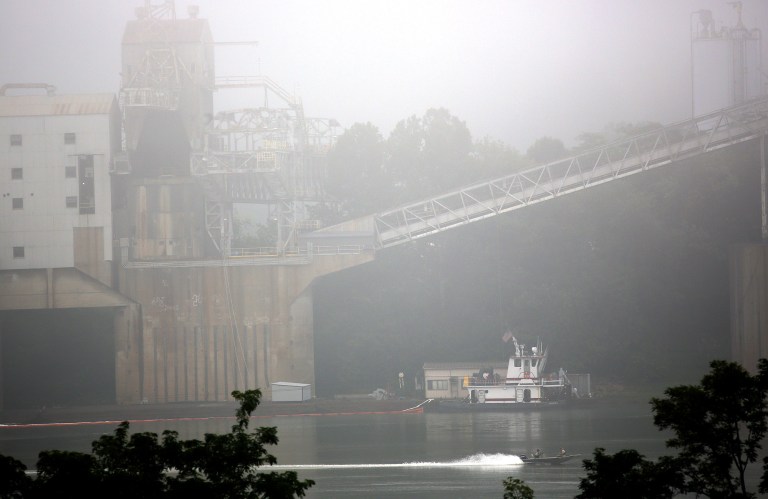 Cleanup is underway near the Beckjord Power Plant, in New Richmond, Ohio, after an estimated 5,000 to 8,000 gallons of fuel oil spilled into the Ohio River, closing about a 15-mile section of the waterway southeast of Cincinnati, on Tuesday, Aug. 19, 2014. (AP Photo/The Cincinnati Enquirer, Amanda Rossmann)