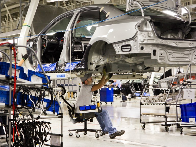In this July 31, 2012, file photo, an employee works on a Passat sedan at the Volkswagen plant in Chattanooga, Tenn. A three-day election on whether workers will be represented by the United Auto Workers union concludes on Friday, Feb. 14, 2014. (AP Photo/Erik Schelzig, file)