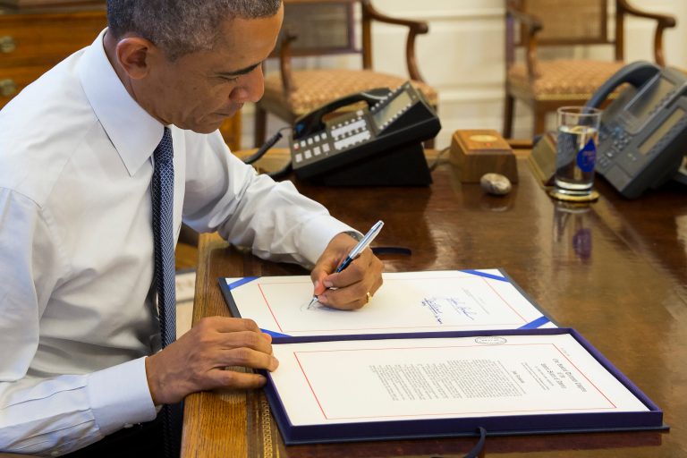 President Obama signs H.J. Res 124 Continuing Appropriations Resolution, which includes appropriations to train and arm moderate Syrian rebels in the fight against the Islamic State group, in the Oval Office of the White House Sept. 19. (AP Photo/Evan Vucci)