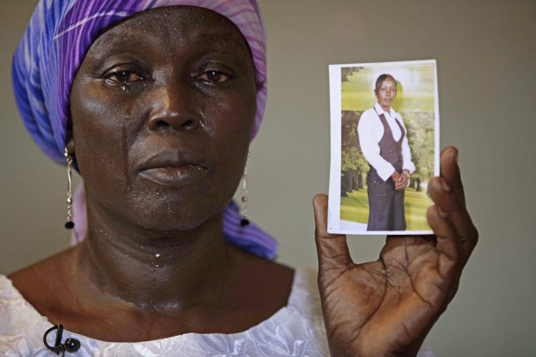 FILE - In this Monday, May 19, 2014 file photo, Martha Mark, the mother of kidnapped school girl Monica Mark, cries as she display her photo in the family house, in Chibok, Nigeria. Islamic extremists have abducted 60 more girls and women and 31 boys from villages in northeast Nigeria, witnesses said Tuesday. Security forces denied the kidnappings. Nigeria's government and military have attracted widespread criticism for their slow response to the abductions of more than 200 schoolgirls kidnapped April 15 (AP Photo/Sunday Alamba,File)