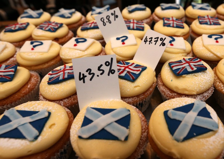 A view of cupcakes decorated with the Union and Scottish Saltire flags, and question marks, along with the results of sales, at Cuckoo's bakery, in Edinburgh, Scotland, Wednesday, Sept. 17, 2014. The bakery has been monitoring the sales of its Union and Saltire flag and undecided cupcakes for 200 days to try and predict the outcome of the referendum. 43.5 percent of sales were Yes cakes, 47.7 percent No, and 8.8 percent undecided.  (AP Photo/Scott Heppell)