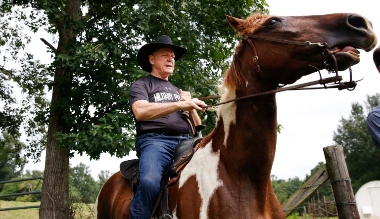 Former Alabama Chief Justice and Senate candidate Roy Moore rides in on a horse named 
