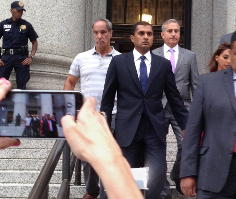 Matthew Martoma,  center right, leaves the courthouse hand-in-hand with wife Rosemary, right, after Martoma, a former portfolio manager convicted of helping his firm earn more than a quarter-billion dollars illegally through insider trading, was sentenced to nine years in prison, Monday, Sept 8, 2014, in New York. (AP Photo/Larry Neumeister)