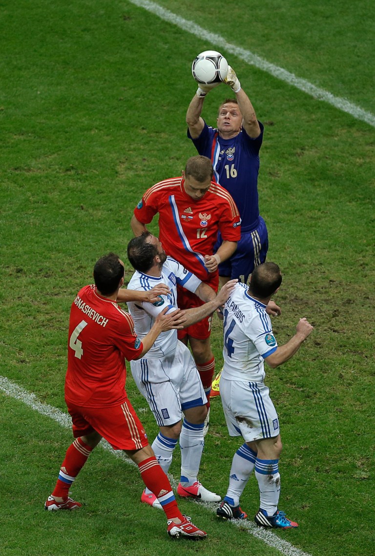   Russia goalkeeper Vyacheslav Malafeev deflects a ball the Euro 2012 soccer championship Group A match between Greece and Russia in Warsaw, Poland, Saturday, June 16, 2012. (AP Photo/Gero Breloer)  