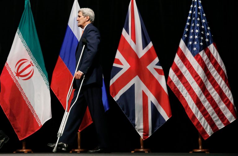 Secretary of State John Kerry leaves the stage after a group picture with foreign ministers and representatives from China, Iran, Britain, Germany, France, and the European Union at the Vienna International Center in Vienna, Austria, Tuesday, July 14, 2015. (Carlos Barria, Pool Photo via AP)