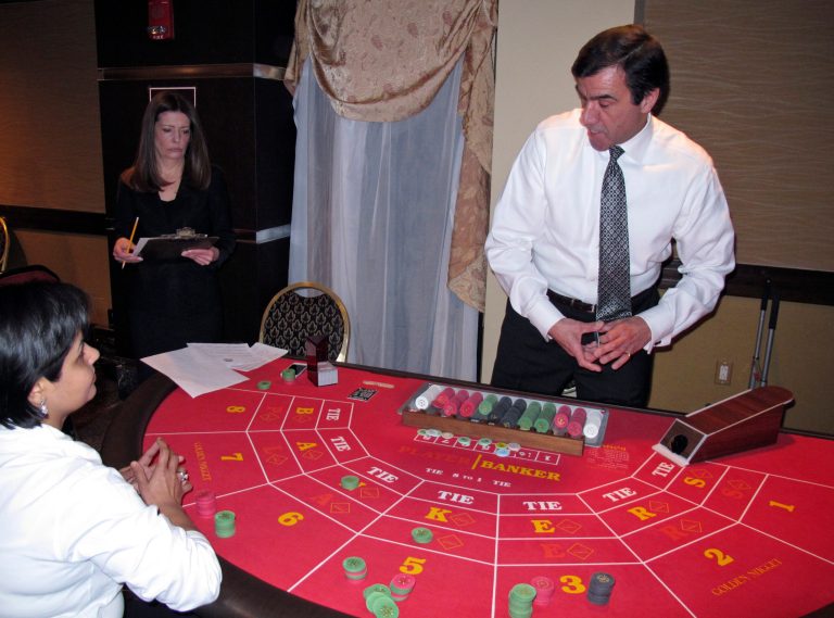 Linda Elefante, left, an assistant shift manager at the Golden Nugget Atlantic City, looks on as an applicant for a casino dealer job auditions at the Golden Nugget Atlantic City in Atlantic City, N.J., on Wednesday, Feb. 26, 2014. More than 1,000 applicants showed up for the 50 jobs that had been advertised. (AP Photo/Wayne Parry)