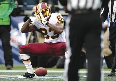 Elaine Thompson/AP
Redskins tight end Fred Davis celebrated his first quarter touchdown against the Seahawks on Sunday by acting like acameraman.