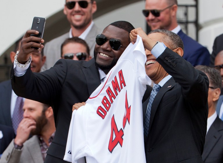 Boston Red Sox designated hitter David Ortiz, left, takes a selfie with President Obama, holding a Boston Red Sox jersey, during a ceremony on the South Lawn of the White House on Tuesday. (AP/Manuel Balce Ceneta)