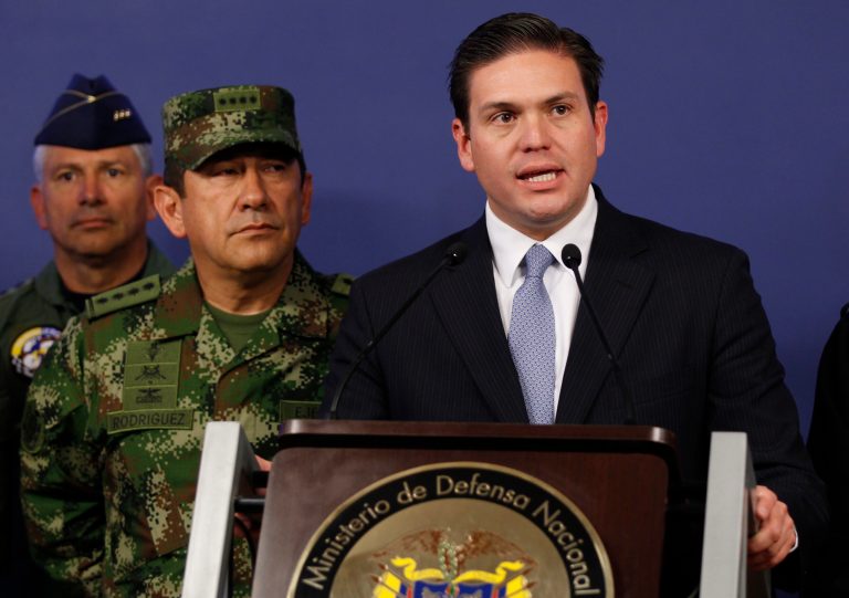 Colombia's Defense Minister Juan Carlos Pinzon, right, speaks as the new chief of the armed forces Gen. Juan Pablo Rodriguez looks on during a press conference in Bogota, Colombia, Tuesday, Feb. 18, 2014. Pinzon named Rodrigues for the post after firing former chief Gen. Leonardo Barrero for verbally maligning prosecutors' investigations into the extrajudicial killings that have brought Colombia international reproach. (AP Photo/Fernando Vergara)