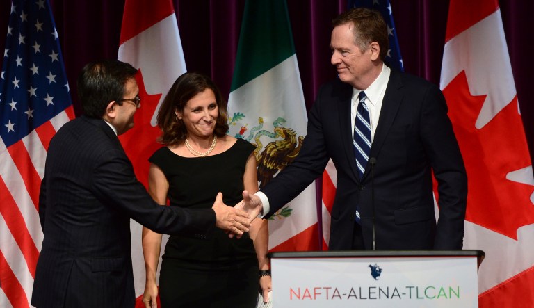 Mexico's Secretary of Economy Ildefonso Guajardo Villarreal, left, shakes hands with U.S. Trade Representative Robert Lighthizer as Canada's Foreign Affairs Minister Chrystia Freeland looks on at a news conference on the NAFTA negotiations in Ottawa on Wednesday, Sept. 27, 2017. (Sean Kilpatrick/The Canadian Press via AP)