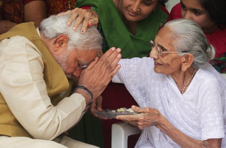 90-year-old Hiraben blesses her son and India's next prime minister Narendra Modi at her home in Gandhinagar, in the western Indian state of Gujarat, Friday, May 16, 2014. The top official in Gujarat state for over a decade, Modi often contrasted his humble roots with the posh background of his main rival, 43-year-old Rahul Gandhi, heir to India's most powerful political dynasty. As the career politician led his party through a dazzling, high-tech election campaign, Modi called voters' attention to his mother riding a three-wheeled auto-rickshaw to cast her ballot earlier this month. 