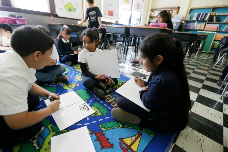 Hispanic students work on reading skills at the Detroit Public Schools' Academy of the Americas in Detroit onÂ Sept. 19, 2014. (AP Photo/Carlos Osorio)