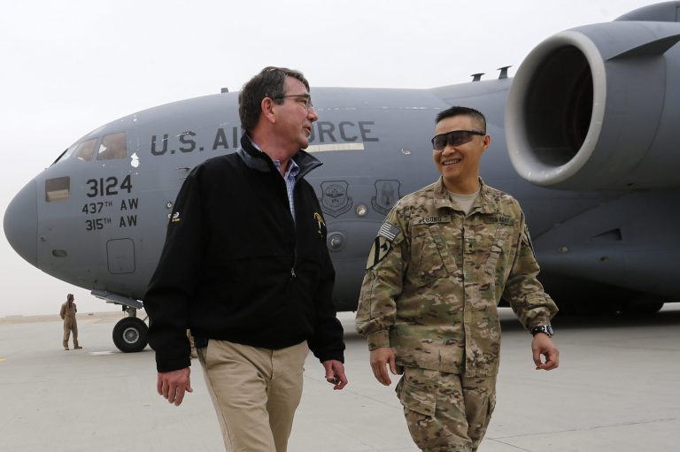 Defense Secretary Ashton Carter, left, speaks with Col. Viet Luong, after his arrival to Kandahar, Afghanistan, Sunday, Feb. 22, 2015. Carter is making his first trip to visit troops and commanders in Afghanistan since his swearing-in this week. (AP Photo/Jonathan Ernst, Pool)