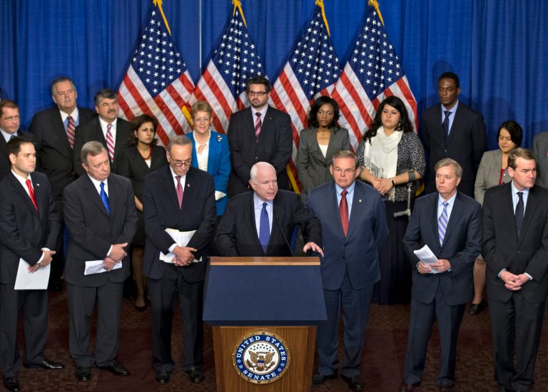 Sen. John McCain, R-Ariz., center, speaks as immigration reform legislation as outlined by the Senate's bipartisan 
