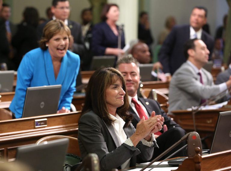 Assemblywoman Diane Harkey, R-Dana Point, center, applauds after the Assembly approved a $7.5 billion water bond measure,  Wednesday, Aug. 13, 2014, in Sacramento, Calif.  The compromise bill was reached between Gov. Jerry Brown and legislative leaders and will replace a water bond measure that is currently on the November ballot. (AP Photo/Rich Pedroncelli)