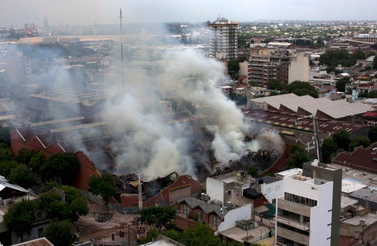 Smoke rises from the Iron Mountain warehouse in Buenos Aires, Argentina, Wednesday, Feb. 5, 2014. Nine first-responders were killed in the fire that destroyed an archive of bank documents, according to authorities. (AP Photo/Rodrigo Abd)