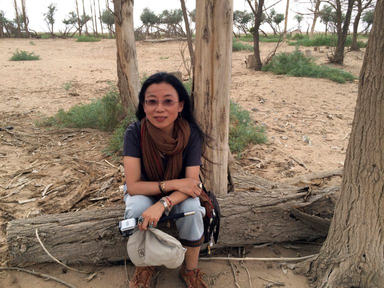 In this June 23, 2014 photo released by Tsering Woeser, well-known Tibetan writer Tsering Woeser poses for a photo in Inner Mongolia in northern China. She said Wednesday, July 9, 2014 that she and her husband have been placed under house arrest in Beijing as China plays host to U.S. State Secretary John Kerry for the latest round of U.S.-China talks. (AP Photo/Wang Lixiong)