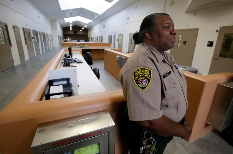 FILE -- In this June 25, 2013 file photo, Correctional Officer Stella Miles stands in one of the secure inmate-patient housing units of the new California Correctional Health Care Facility in Stockton, Calif.  Gov. Jerry Brown is seeking millions of dollars in his revised 2014-15 state budget plan to correct problems in the recently constructed $839 million facility  the can treat up to 1,720 inmate-patients. (AP Photo/Rich Pedroncelli)