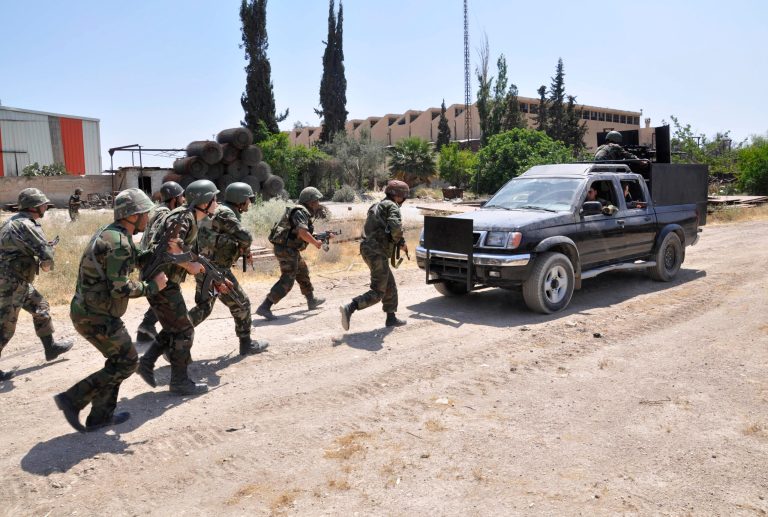 In this photo released on Sunday, May 26, 2013, by the Syrian official news agency SANA, Syrian forces loyal to Syrian President Bashar Assad take their position during clashes against Syrian rebels, in Aleppo, Syria. Syria's Information Ministry says rebels have killed a TV correspondent who was covering clashes near the border with Lebanon. (AP Photo/SANA)
