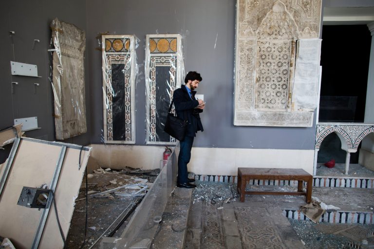 An UNESCO delegation member records the damage of the Museum of Islamic Art in Cairo, Egypt, Friday, Jan. 31, 2014. The U.N. agency visited the museum where centuries-old artifacts were destroyed by a bombing that also ripped through the nearby Cairo police headquarters a week ago. (AP Photo/Hassan Ammar)
