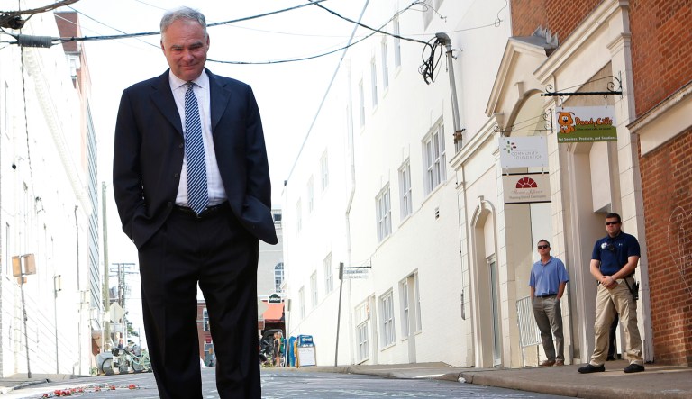 Sen. Tim Kaine visits a makeshift memorial Wednesday, Aug. 16, 2017, where Heather Heyer was killed Saturday when a car rammed into a crowd of people protesting a white nationalist rally Charlottesville, Va. (AP Photo/Julia Rendleman)