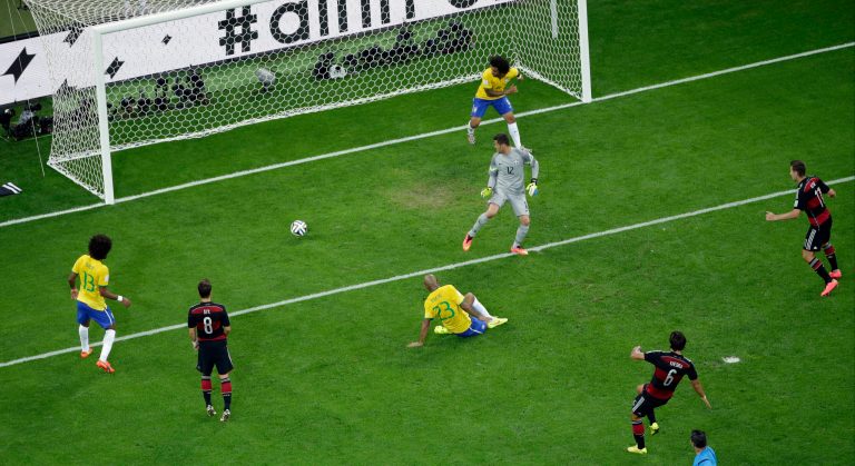 Germany's Sami Khedira, bottom, scores his side's 5th goal during the World Cup semifinal soccer match between Brazil and Germany at the Mineirao Stadium in Belo Horizonte, Brazil, Tuesday, July 8, 2014. (AP Photo/Felipe Dana, Pool)