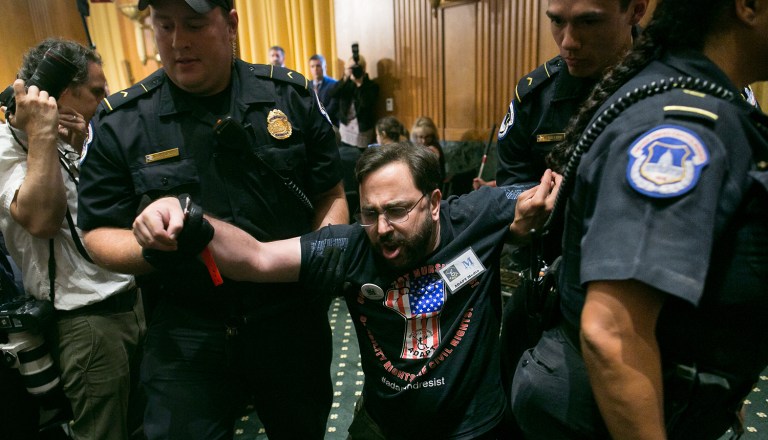 A protester opposed to the GOP's Graham-Cassidy health care repeal bill is removed by U.S.Capitol Police after disrupting a Senate Finance Committee hearing on GOPs latest attempt to overhaul the nation's health care system, on Capitol Hill, Monday. (Graeme Jennings/Washington Examiner)