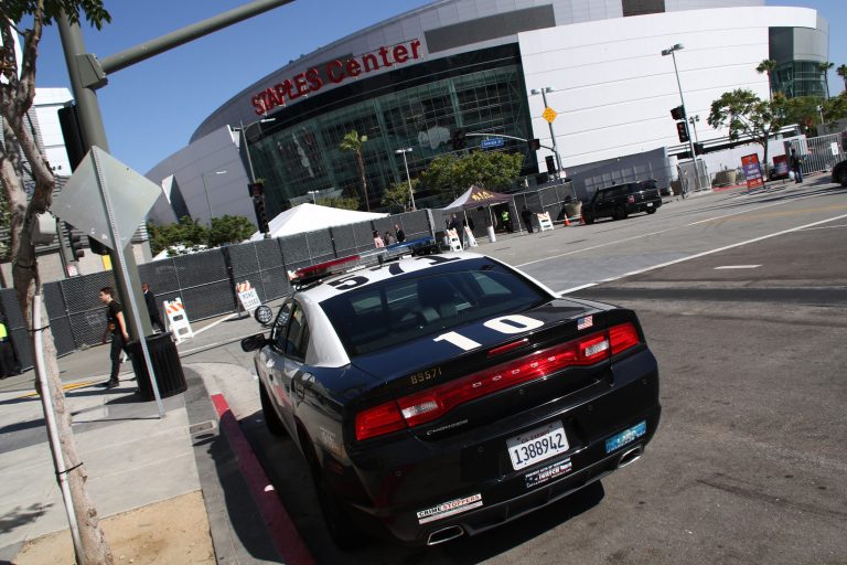 A police car is parked outside of the entrance of the Los Angeles premiere of 