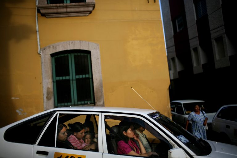   FILE - In this Sept. 24, 2009 file photo, passengers ride in a taxi in downtown Tegucigalpa, Honduras. Taxi drivers are known to pay extortionists more than $500 a year to park on public property. During Christmas, the cabbies dish out another $500 each in holiday âbonuses.â This capital of 1.3 million people is a lawless place, but it does seem to have its own set of unwritten rules for living with the daily dangers. (AP Photo/Rodrigo Abd, File)  