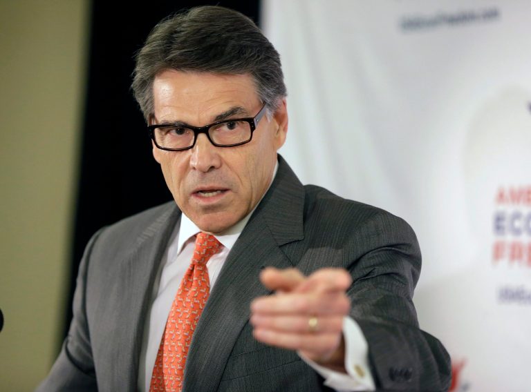 Texas Gov. Rick Perry speaks to reporters at the California Republican Party convention in Anaheim, Calif., on Oct. 4. (AP Photo/Reed Saxon)