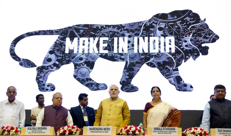 Indian Prime Minister Narendra Modi, center, unveils the logo of 'Make in India' initiative in New Delhi, India, Thursday, Sept. 25, 2014. Scores of business leaders from India and abroad attended the launch of the initiative where in the Indian Prime Minister called on manufacturers across the globe to come and make India a manufacturing hub. (AP Photo/Saurabh Das)