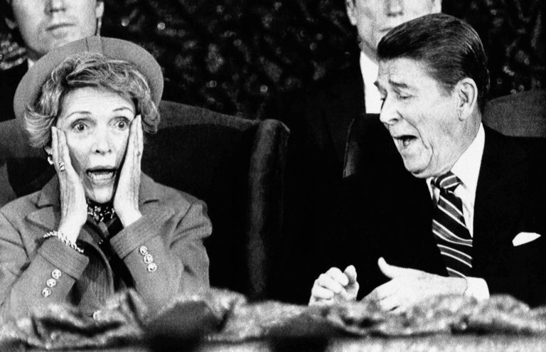 President Ronald Reagan and wife Nancy react after Mrs. Reagan sat down after speaking and forgot to introduce the President at the Capital Center in Landover, Md., Monday, Jan. 21, 1985, during an event held for those who would have participated in the inaugural parade, which was canceled because of bad weather.