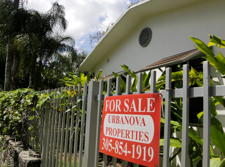 This Monday, May 19, 2014 photo shows a duplex home for sale in the Coconut Grove neighborhood in Miami. Freddie Mac releases weekly mortgage rates on Thursday, July 3, 2014. (AP Photo/Lynne Sladky)