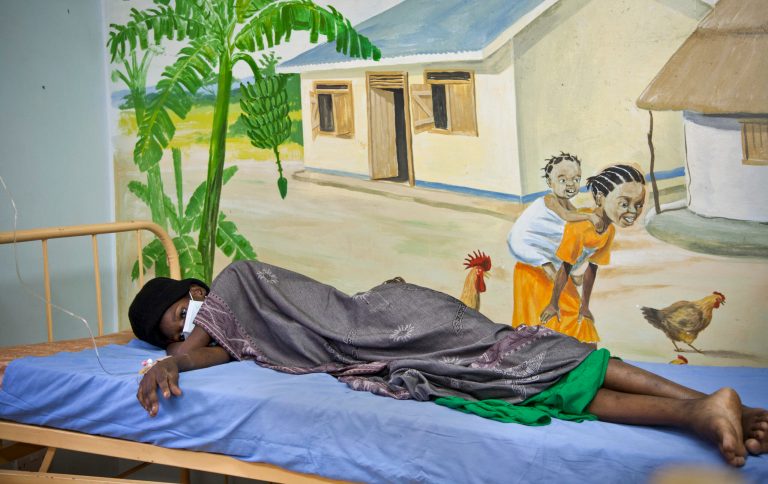 A newly-diagnosed HIV positive woman, who arrived at the hospital with symptoms of tuberculosis (TB), lies in the treatment ward of the Mildmay Uganda clinic, which receives funding from the US government through the Centers for Disease Control and Prevention (CDC), in Kampala, Uganda Thursday, Feb. 27, 2014. Uganda's government has been hit with substantial aid cuts after the president enacted a severe anti-gay measure over which some Western governments had warned of consequences, and at least three European countries are withdrawing millions in direct support to Uganda's government, which depends on donors for about 20 percent of its budget. (AP Photo/Rebecca Vassie)