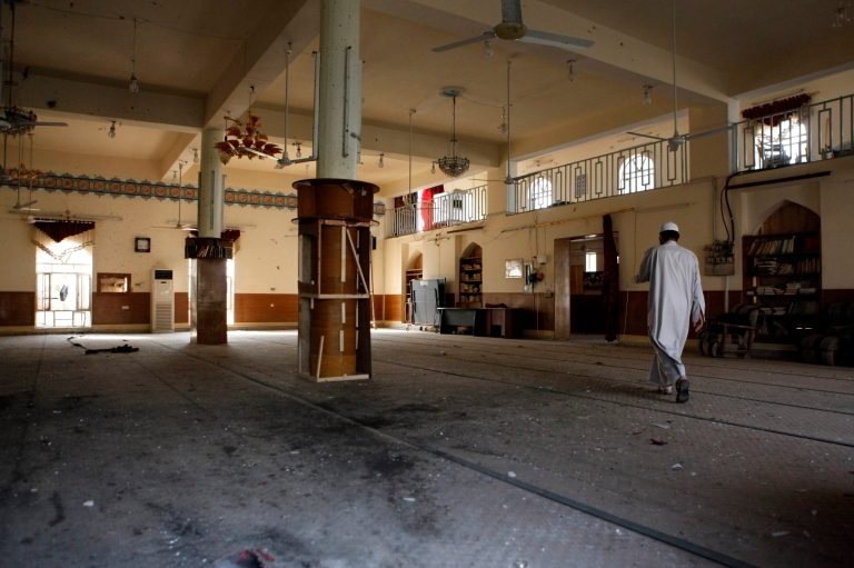 In this Wednesday, May 8, 2013 photo, an Iraqi cleric walks inside a damaged Sunni mosque in western Baghdad, Iraq. Attacks on mosques, especially where Sunnis worship, have been on the rise recently. Iraqi officials have warned that insurgents are trying to take advantage of the country's political and sectarian turmoil by targeting mosques in an attempt to reignite civil strife in the country. The mosque was attacked two weeks ago. (AP Photo/Hadi Mizban)
