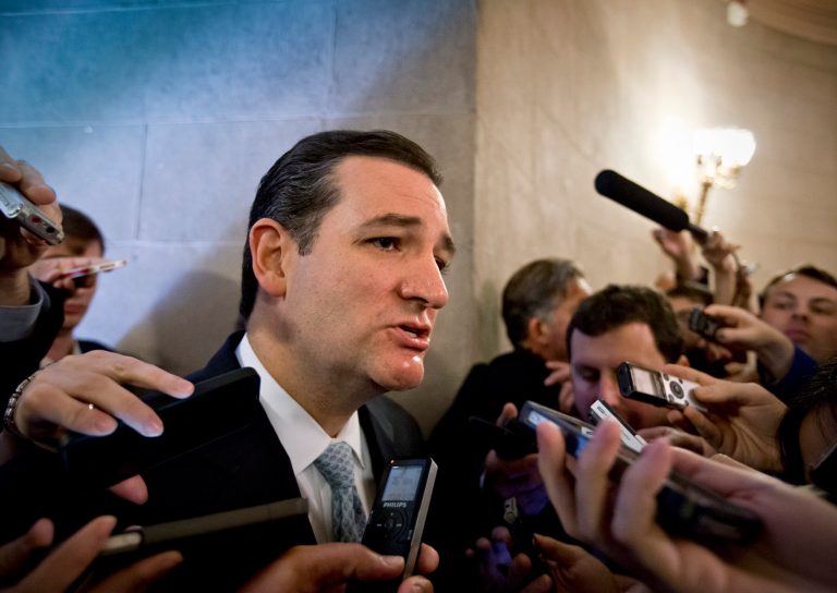 Sen. Ted Cruz, R-Texas, speaks to reporters waiting outside a closed-door meeting of Senate Republicans as news emerged that leaders reached a last-minute agreement to avert a threatened Treasury default and reopen the government after a partial, 16-day shutdown, at the Capitol in Washington, Wednesday, Oct. 16, 2013. Cruz said he would not try to block the agreement.   (AP Photo/J. Scott Applewhite)