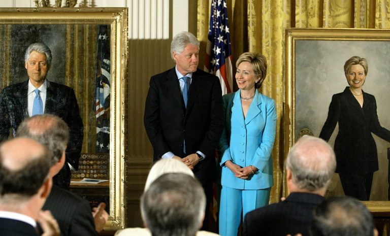 Former U.S. President Bill Clinton and his wife U.S. Senator Hillary Clinton (D-NY) look at the newly unveiled Clinton portraits in the East Room of the White House June 14, 2004 in Washington, DC. The artist, Simmie Knox, is the first black portraitist to paint an official presidential portrait. (Photo by Mark Wilson/Getty Images)