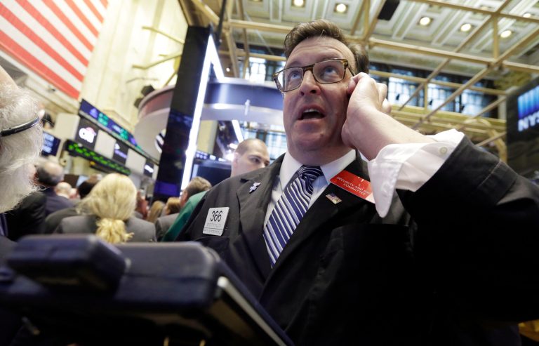 FILE - In this July 16, 2014 file photo, trader Benedict Willis uses his moblie phone as he works on the floor of the New York Stock Exchange. Stocks are pricier, tensions between Russia and the West are mounting, and Israel has rolled into Gaza to stop a deadly air war. And yet investors shrug it all off and keep pushing the market higher. (AP Photo/Richard Drew, File)