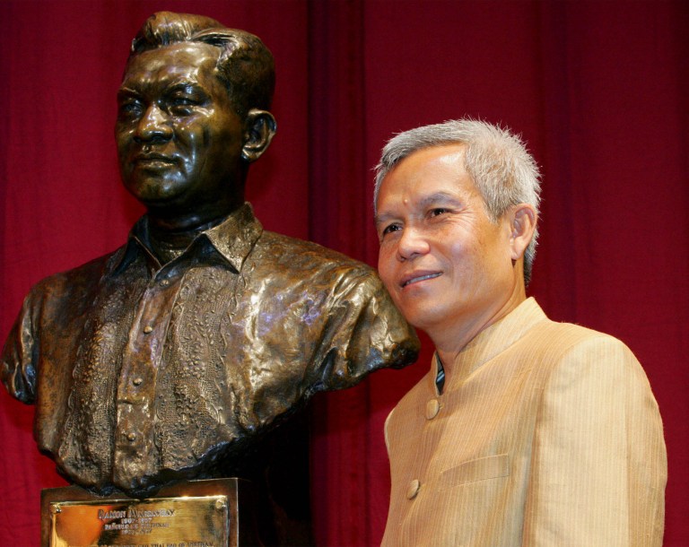   FILE - In this Aug. 31, 2005 file photo, Sombath Somphone of Laos, the winner of Ramon Magsaysay Award for Community Leadership in 2005, poses with the bust of the late Philippine president prior to receiving his award in ceremony at the Cultural Center of the Philippines in Manila. The respected social activist has gone missing in Laos, and a colleague involved in the search for him said that he saw evidence that police had taken him into custody. A statement issued Tuesday, Dec. 18, 2012 on behalf of 61 Thai nongovernmental organizations said Sombath disappeared Saturday afternoon in the Lao capital, Vientiane, where friends last saw him getting into his car to drive home from the development agency he founded. The Ramon Magsaysay Award is one of Asia's top civil honors. (AP Photo/Bullit Marquez, File)  