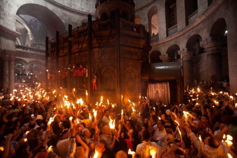 Christian pilgrims hold candles at the church of the Holy Sepulcher, traditionally believed to be the burial site of Jesus Christ, during the ceremony of the Holy Fire in Jerusalem's Old City, Saturday, April 19, 2014. The 