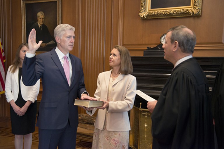 Chief Justice John G. Roberts, Jr., administers the constitutional oath to Judge Neil M. Gorsuch in the Justices' Conference Room, Supreme Court Building. Louise Gorsuch holds the Bible. (Franz Jantzen, Collection of the Supreme Court of the United States)
