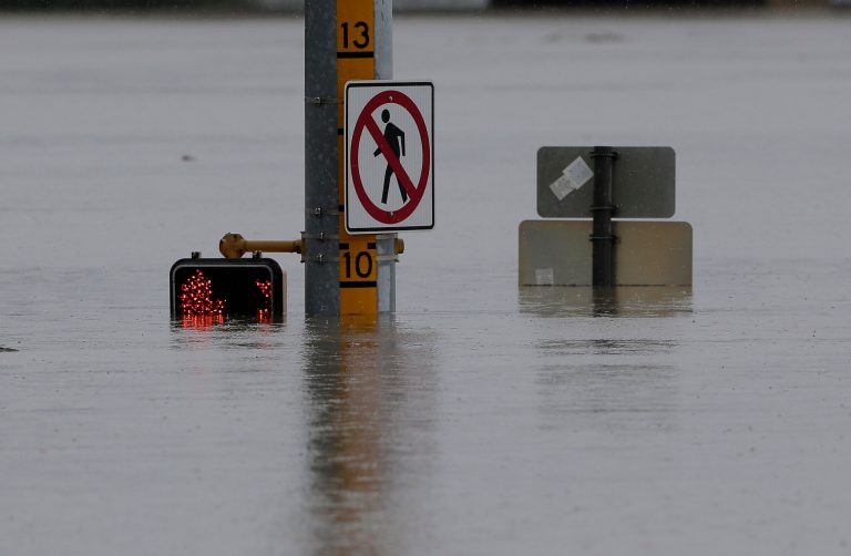 A flood gage shows waters just under 10 feet at an intersection, Saturday, May 25, 2013, in San Antonio. (AP Photo/Eric Gay)