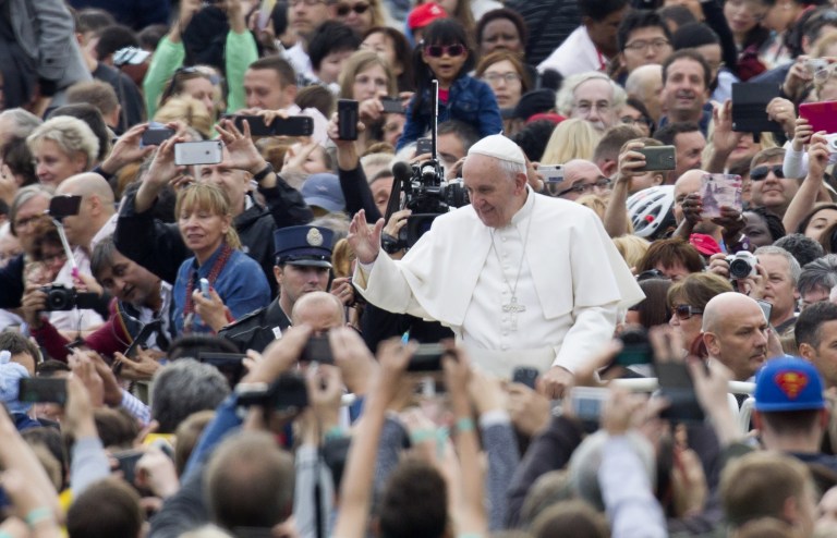 Pope Francis waves to faithful as he arrives for his weekly general audience in St. Peter's Square, at the Vatican, Wednesday, Sept. 30, 2015. (AP Photo/Riccardo De Luca)