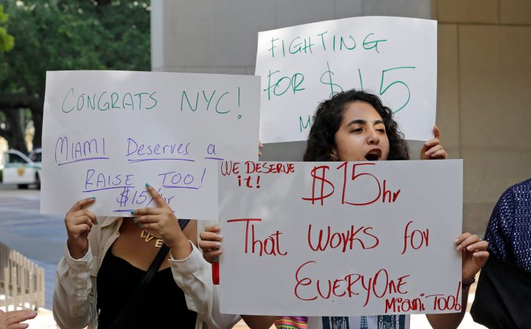 Beatriz Rivera chants slogans supporting to set minimum wages at $15 an hour as New York's wage board recommended, Wednesday, Thursday, July 23, 2015, in downtown Miami. (AP Photo)Â 